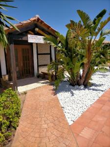 a brick walkway leading to a building with a sign at Finca Esmeralda in Zahora