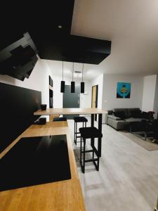 a kitchen and living room with a table and chairs at Apartamenty HashtagWilda in Poznań