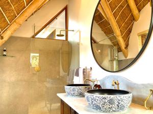 a bathroom with two sinks and a mirror at The Guardian Hermanus Luxury Self-Catering Hemel en Aarde Valley in Hermanus +74 photos