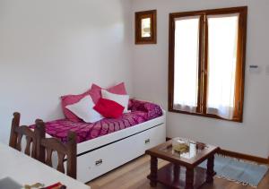a room with a couch with a mirror and a window at La MagnoliaII zona Güemes in Mar del Plata
