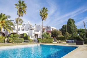 a large white house with a swimming pool and palm trees at BayMar by MarCalma in Montroig