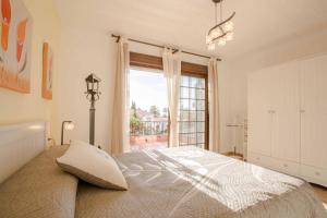 a bedroom with a bed and a large window at BayMar by MarCalma in Montroig +43 photos