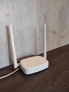 a white router sitting on top of a wooden floor at Comfortable apartments in centre with 3 bedrooms in Rivne