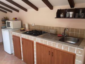 a kitchen with a sink and a stove top oven at La mansarda del Sacro Bosco in Bomarzo