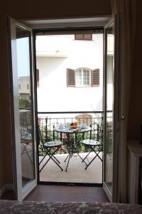 una porta scorrevole in vetro che conduce a un patio con tavolo di B&B Hortis Tropea a Tropea