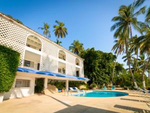 un complejo con piscina y palmeras en Maravillosa casa con 7 habitaciones, acceso directo a playa pichilingue, bahía de puerto marqués, zona diamante Acapulco, en Acapulco