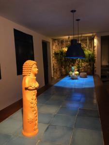 a statue of a woman in a room with blue lights at Guest House & Art Gallery in Olinda