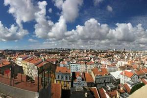 a view of a city with buildings and clouds at The Blue Sky Nest in Lisbon