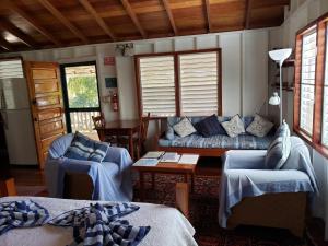 a living room with a couch and a table at Carolyn's Other House- Gold Standard Certified in Caye Caulker