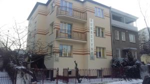 a building with a fence in front of it at Bursztynek in Gdynia