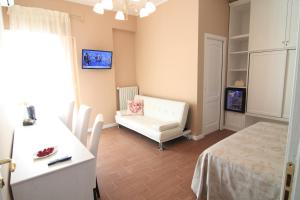 a living room with a white couch and a chair at B&B Hortis Tropea in Tropea