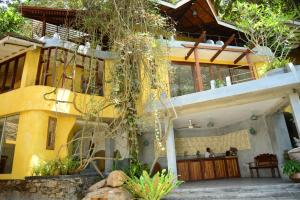 a large yellow building with a restaurant in it at Thambapanni Retreat in Unawatuna