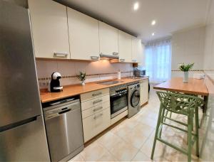 a kitchen with a stainless steel refrigerator and a counter at LA CASA DE CRISTINA Y NEREA - RIBADESELLA in Ribadesella