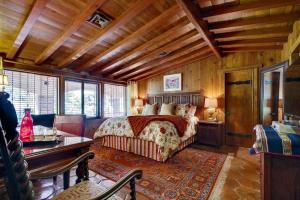 a bedroom with a bed and a wooden ceiling at Vineyard Hacienda in El Cajon