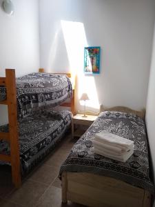 A bed or beds in a room at Complejo Viejo Sulky