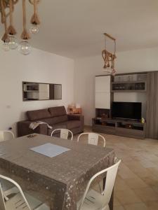 a living room with a table and a couch at Casa BiBa in Villasimius