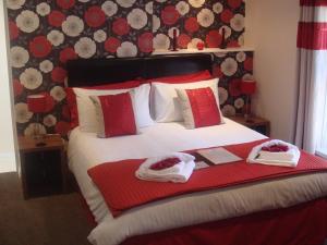 a bedroom with a bed with two towels on it at The Fawley Guest house in Shanklin