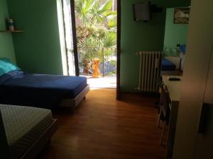 a room with a bedroom with a bed and a door at I Pini B&B in Castagnito
