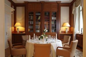 a dining room with a table and chairs at Villa Hammerschmiede in Söllingen