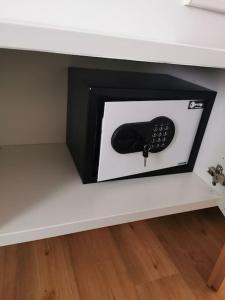 a picture of a remote control sitting on a shelf at Apartman PIKY No.10 in Moravske Toplice