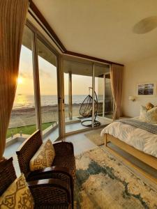 a bedroom with a bed and a view of the ocean at Oceana View in Swakopmund