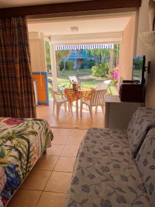 a bedroom with a bed and a table and chairs at Studio a Sainte Anne a 130 m de la plage avec terrasse in Sainte-Anne