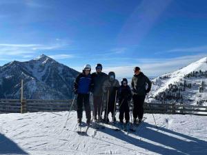 a group of people standing on top of a ski slope at Utah Valley Retreat - Luxurious Self check-in Apt, UVU BYU, EV Charge in Orem