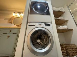 a washer and dryer in a kitchen with a counter at Utah Valley Retreat - Luxurious Self check-in Apt, UVU BYU, EV Charge in Orem