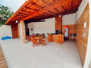 a patio with a table and chairs and a table and chairsktop at Pousada Brilho dos Lençóis in Barreirinhas