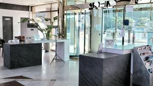 a store with glass windows and a desk with a laptop at Hotel Marine in Pohang