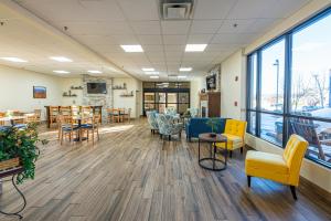 a waiting room with chairs and tables and windows at River Bend Inn - Pigeon Forge in Pigeon Forge