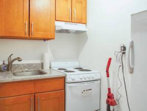 a kitchen with a white stove and a vacuum at Downtown Studio Apt, Near Grocery And Hospitals in Boston