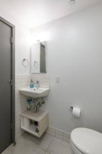 a white bathroom with a toilet and a sink at Small Fully Equipped Contemporary Studio Near MGH in Boston