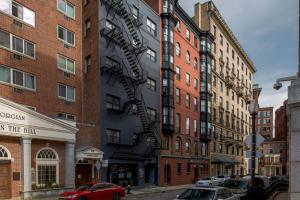 a building with a spiral staircase on the side of it at Small Fully Equipped Contemporary Studio Near MGH in Boston