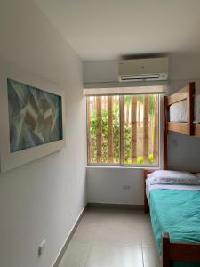 Habitación pequeña con 2 camas y ventana en Zorritos-playa, en Lima