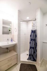 a bathroom with a shower and a sink at Modern Studio In City Center, Near Boston Common in Boston
