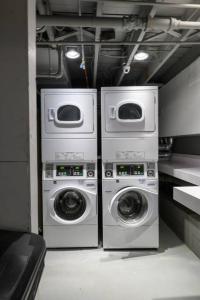 three washing machines and a washer and dryer in a room at Modern Studio In City Center, Near Boston Common in Boston