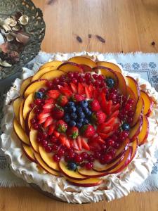 a cake with fruit on top of it on a table at Casale delle Rondini in Tolentino