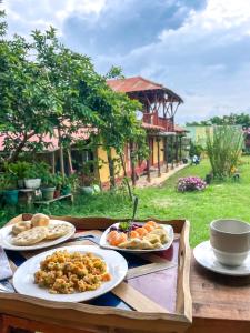 a table with three plates of food on it at Cabaña Numbana San Agustín in San Agustín