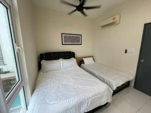 a bedroom with two beds and a ceiling fan at Camellia Mesahill Homestay in Nilai