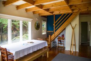 a bedroom with a bed and a staircase at Fern Lodge Coromandel in Coromandel Town