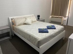 a bedroom with a bed with two towels on it at Leigh Creek Outback Resort in Leigh Creek