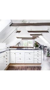 a large kitchen with white cabinets and a window at D'Lyon Stud and Sporthorses in Asarum