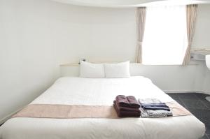 Postel nebo postele na pokoji v ubytování Hotel Imalle Yokohama Isezakicho
