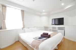 Postel nebo postele na pokoji v ubytování Hotel Imalle Yokohama Isezakicho