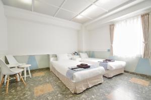 Postel nebo postele na pokoji v ubytování Hotel Imalle Yokohama Isezakicho