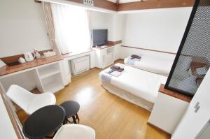 Postel nebo postele na pokoji v ubytování Hotel Imalle Yokohama Isezakicho
