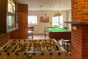 a kitchen with a stove and a pool table at The Strathcarron Hotel in Strathcarron