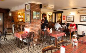 a restaurant with people sitting at tables in a restaurant at The Strathcarron Hotel in Strathcarron