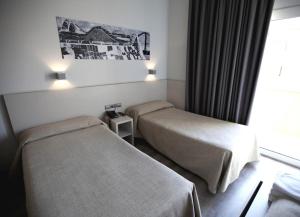 Posteľ alebo postele v izbe v ubytovaní Hotel Ciutat De Sant Adria